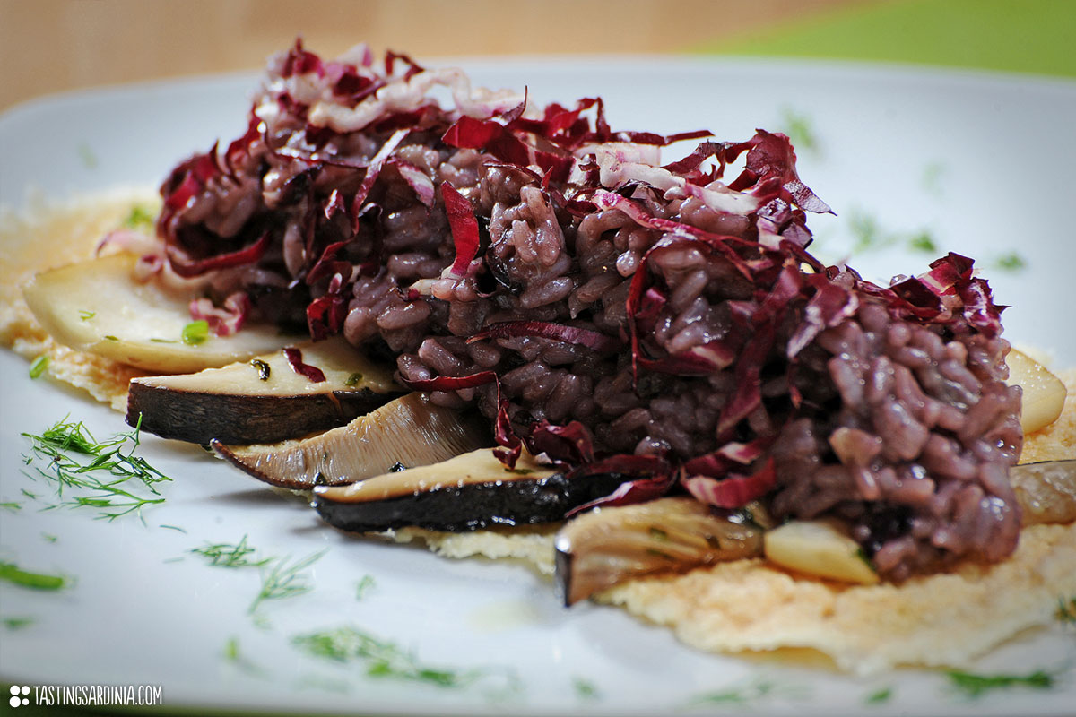 Red-leafed chicory rice on pecorino slab with cardoncelli