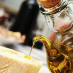 pouring some olive oil over a bread slice for an oil tasting