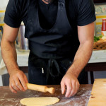 chef Ivo teaching out to roll out the dough by hands with a rolling pin