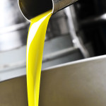 fresh olive oil pouring from the grinder