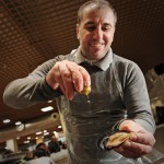 fishmongers pourings some drops of lemon for a tasting during the market experience