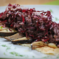 Red-leafed chicory rice on pecorino slab with cardoncelli