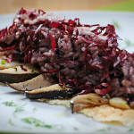 Red-leafed chicory rice on pecorino slab with cardoncelli