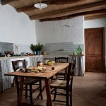 the old kitchen with some wine and cheese on the table