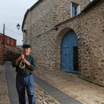 the blue front door of Domu Antiga in the paved stone street