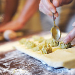 stuffing ravioli during home-made pasta cooking lesson